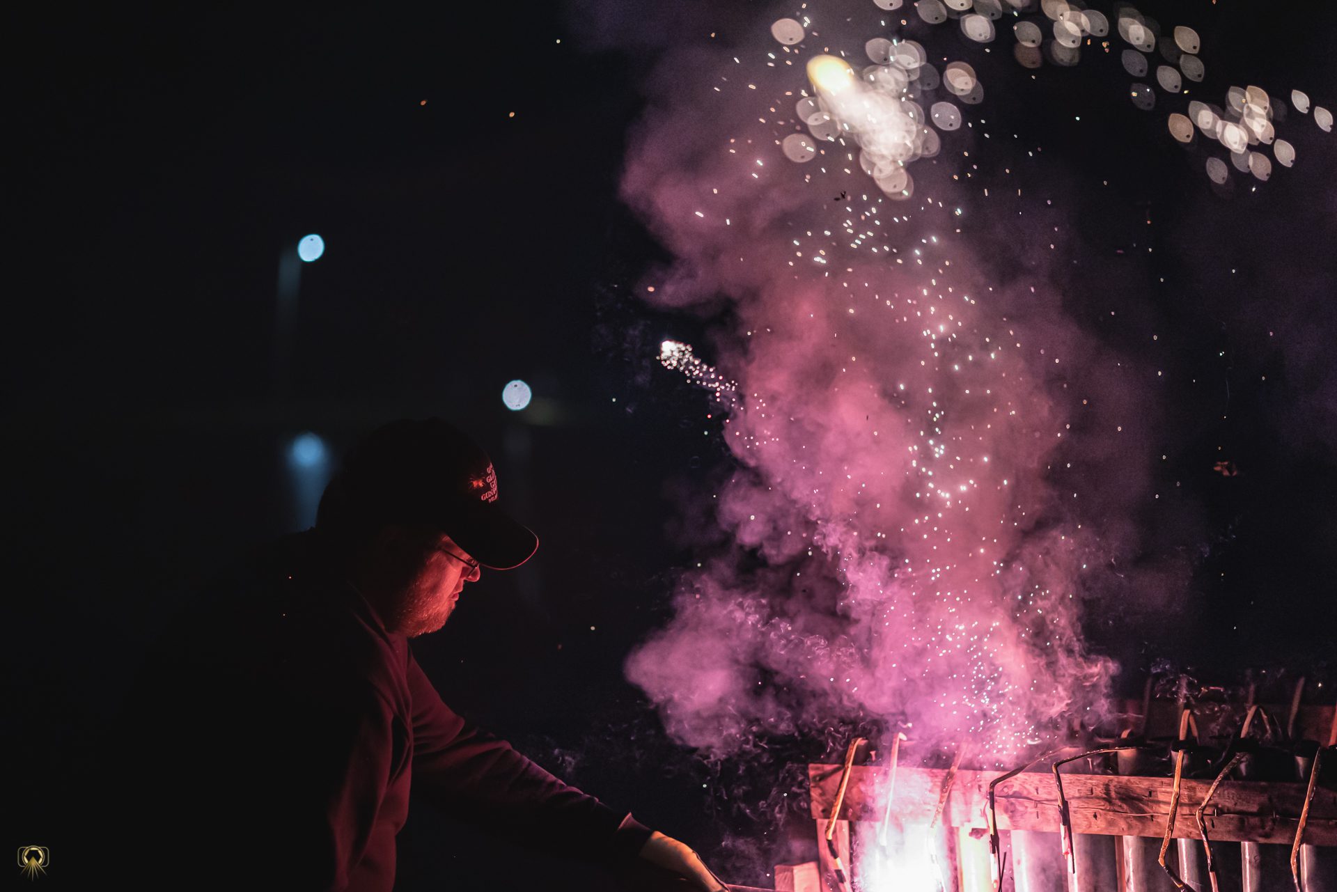 Man lighting fireworks in the dark